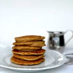 pancakes sitting in a stack on a white plate